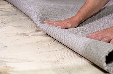 Interior designers selecting marble and terrazzo samples for a tile flooring store showroom.