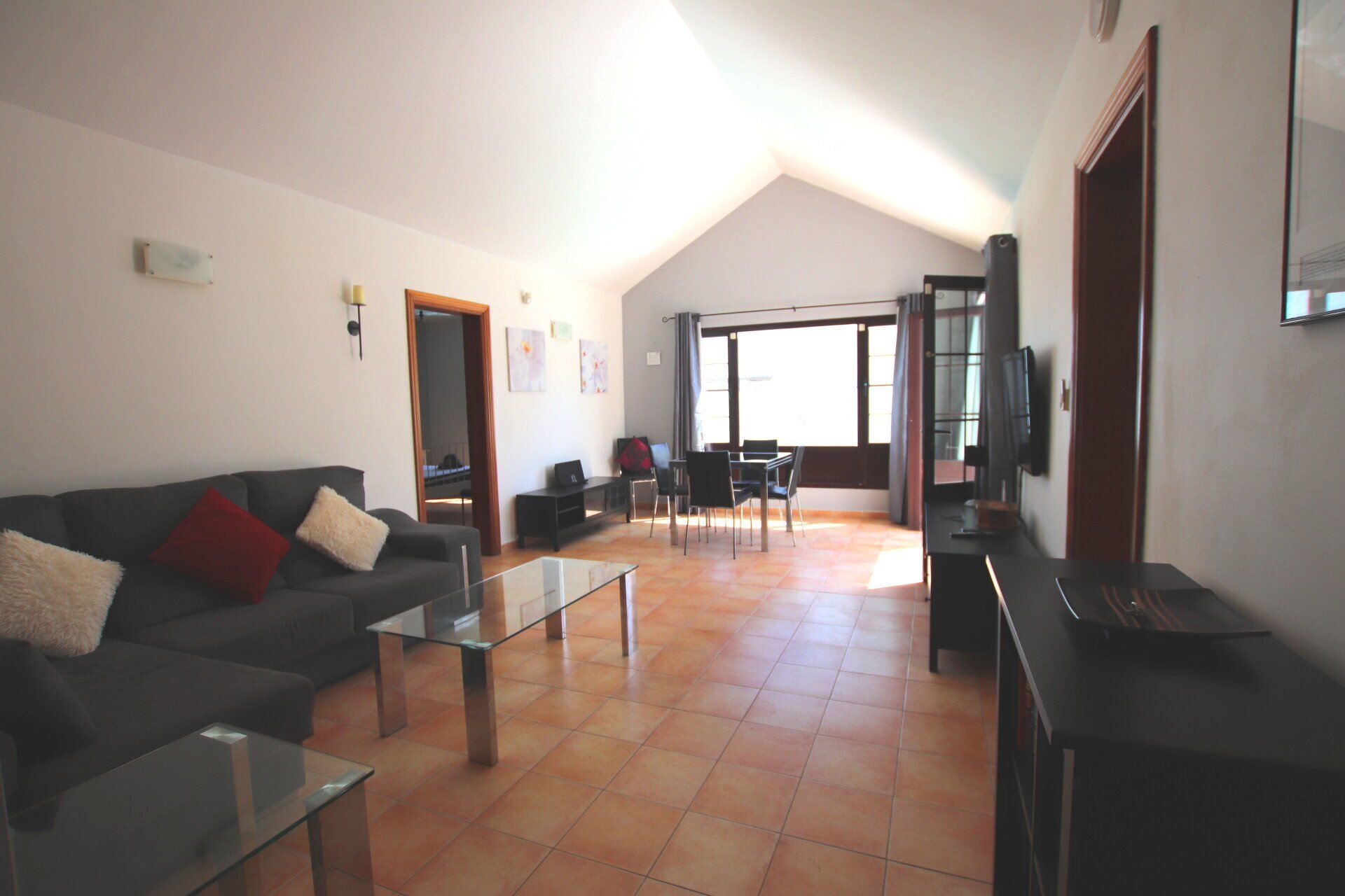 A living room with a couch a table and a television