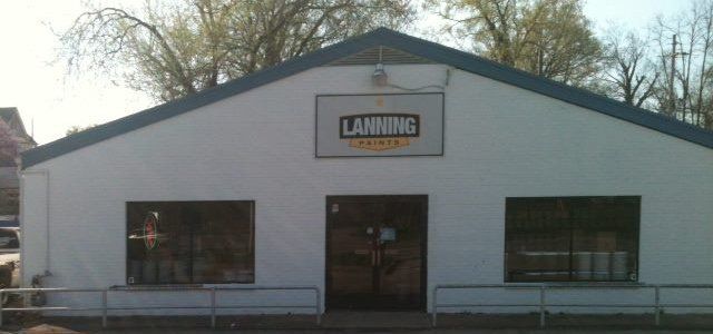 Front view of a white tanning salon building with a sign above the entrance.