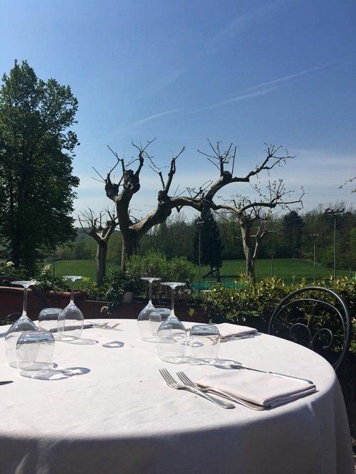 un tavolo rotondo apparecchiato e vista degli alberi