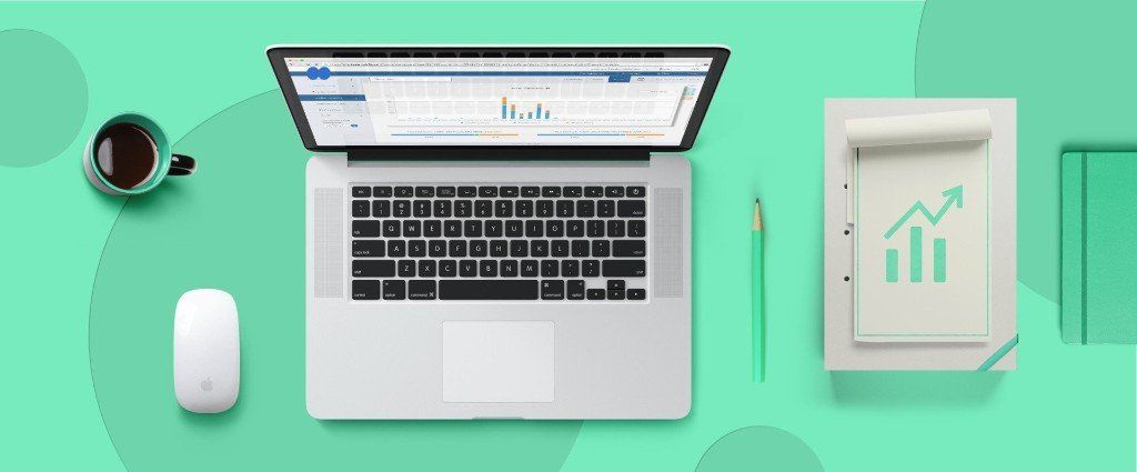 A laptop computer is sitting on a desk next to a cup of coffee and a mouse.