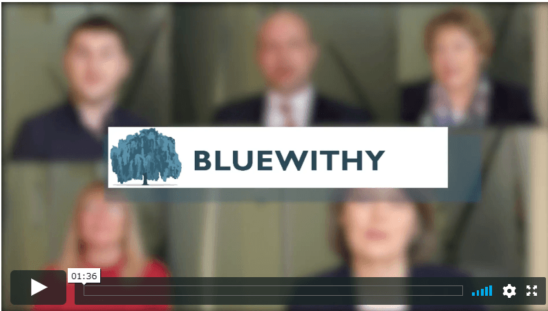 A group of people are sitting in front of a bluewithy logo