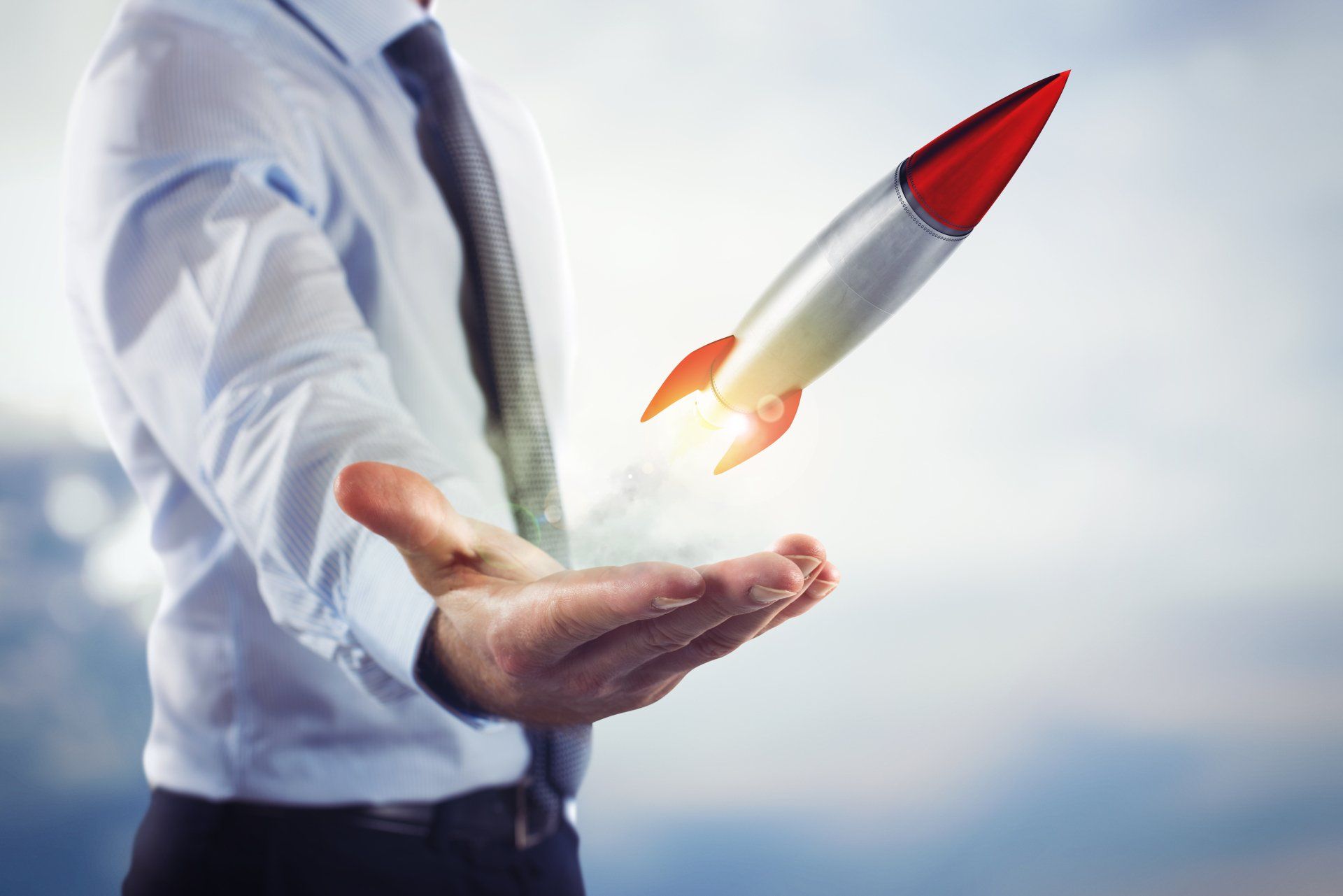 A man is holding a rocket in his hand