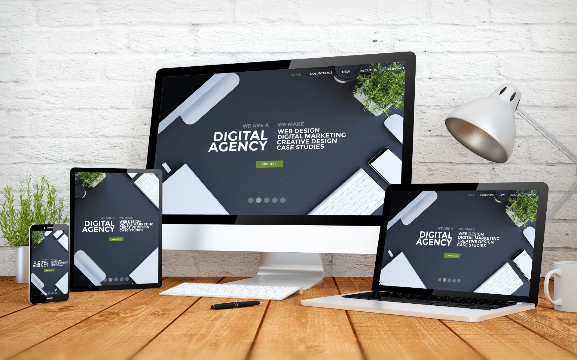 A digital agency website is displayed on a computer monitor tablet and laptop