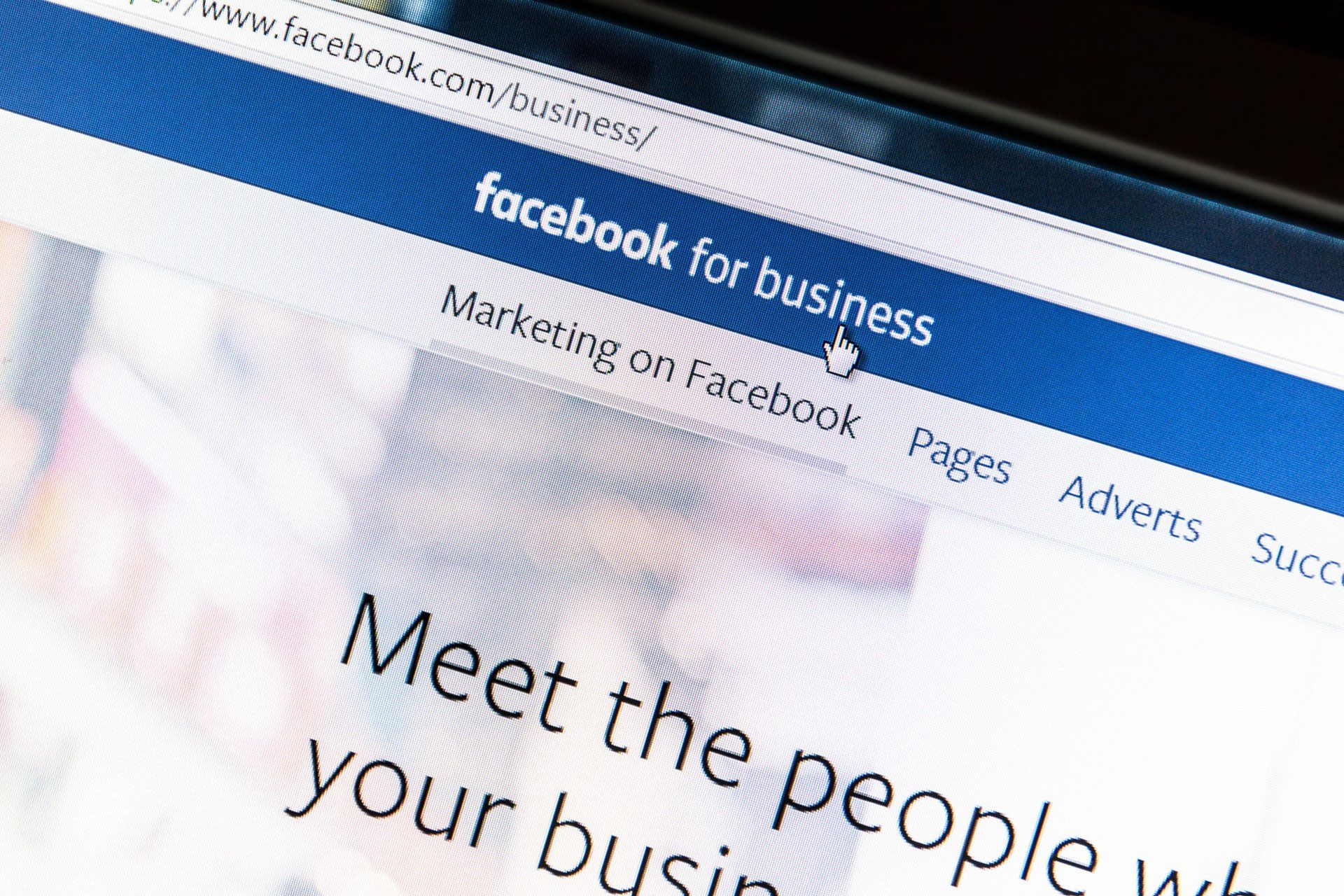 A computer screen shows a facebook for business page