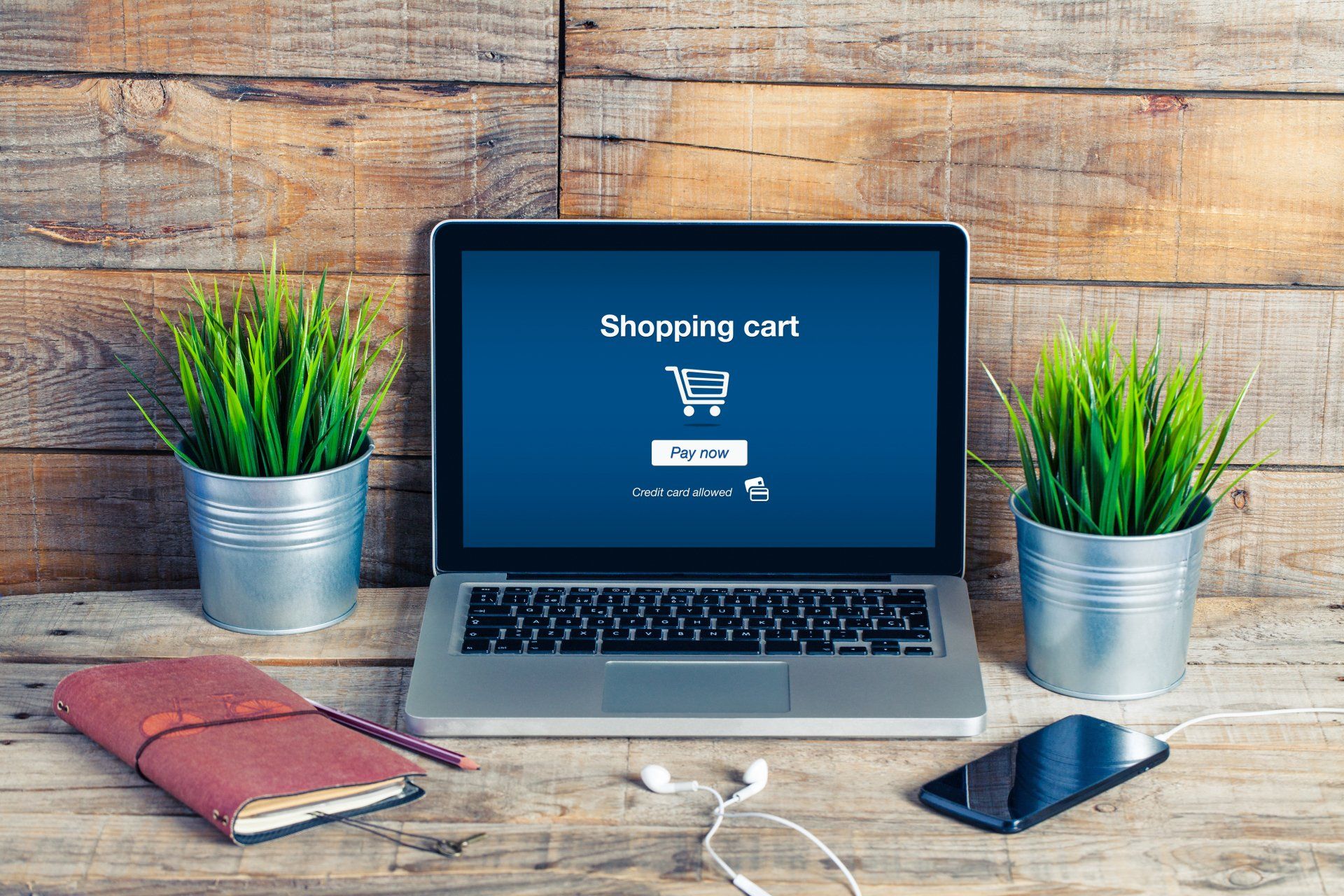 A laptop is open to a shopping cart page