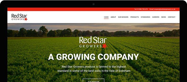 A computer screen shows a growing company website