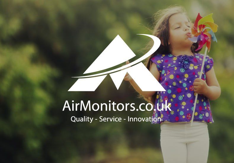 A little girl blowing a windmill in front of an airmonitors.co.uk logo