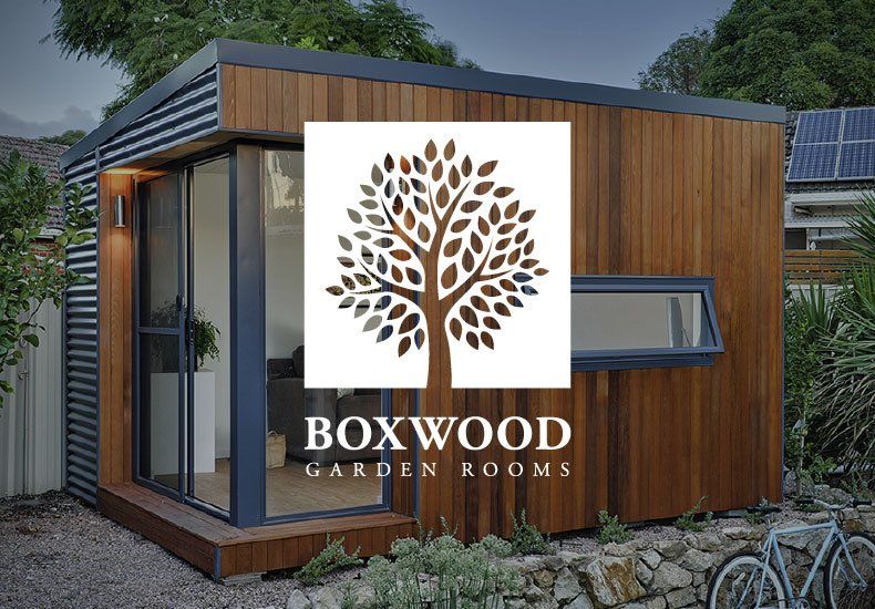 A picture of a boxwood garden room with a tree on it