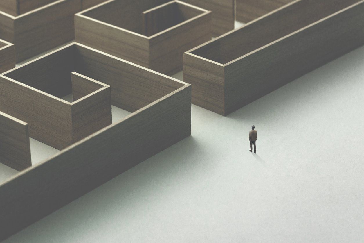 A man is standing in the middle of a maze.