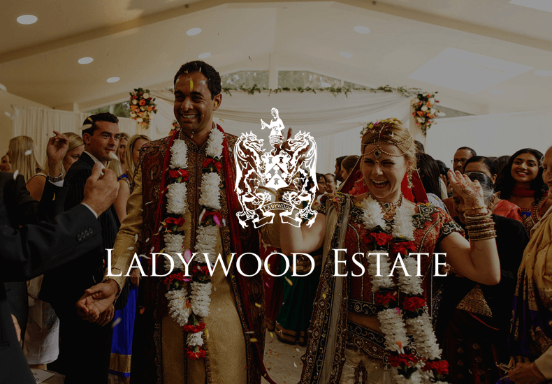 A bride and groom are walking down the aisle at ladywood estate