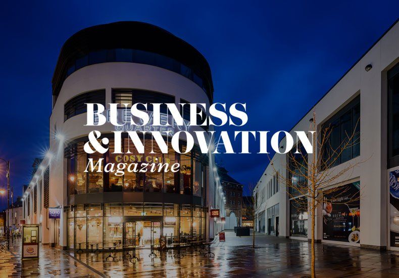 A business and innovation magazine cover with a building in the background