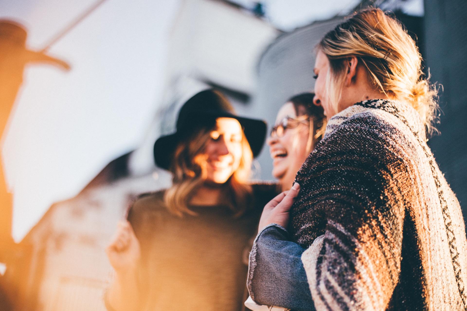 A group of women are standing next to each other and laughing