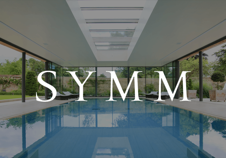A large indoor swimming pool with the word symm above it