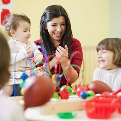 Learning Center — A Woman Clapping With The Kids In Stratford, NJ