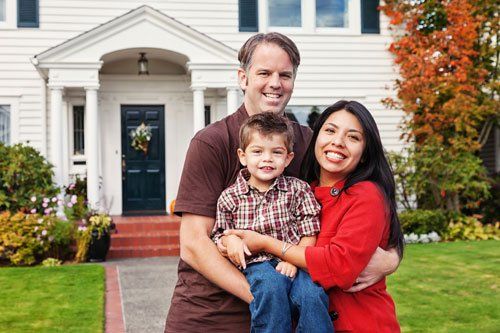 Family in front of home