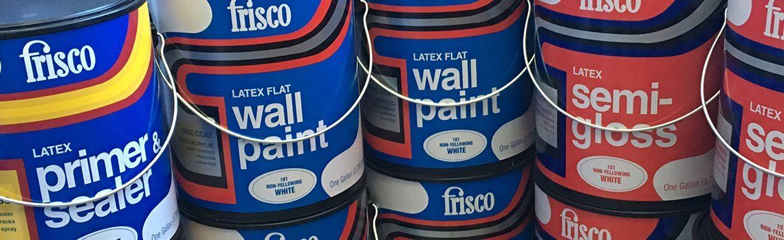 Several cans of Frisco paint in a variety of colors, including blue and red, are lined up in a store.