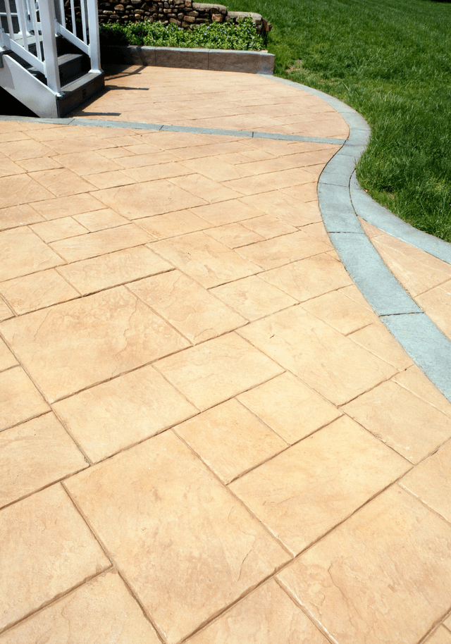 This is a picture of a stamped concrete patio in a backyard.  The concrete is a beige colour with a grey border.  The second picture is of a stamped concrete walkway.  The third picture is of a freshly poured concrete slab on grade.  The fourth picture is of textured and colored concrete.  The fifth picture is of a new concrete driveway.  The sixth picture is of a concrete pool deck.