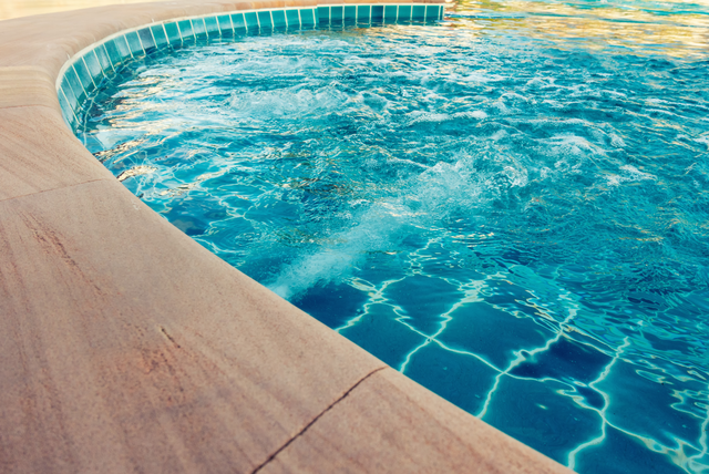 Picture of a concrete pool deck. The picture is taken closeup.