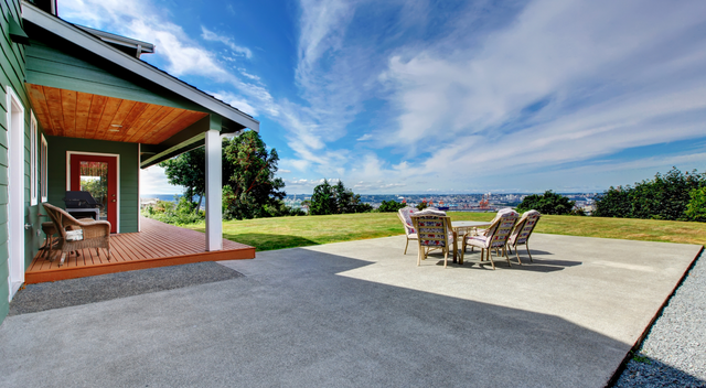 This is a picture of a concrete slab on grade.   It is a new concrete patio outside of a house on top of a hill.
