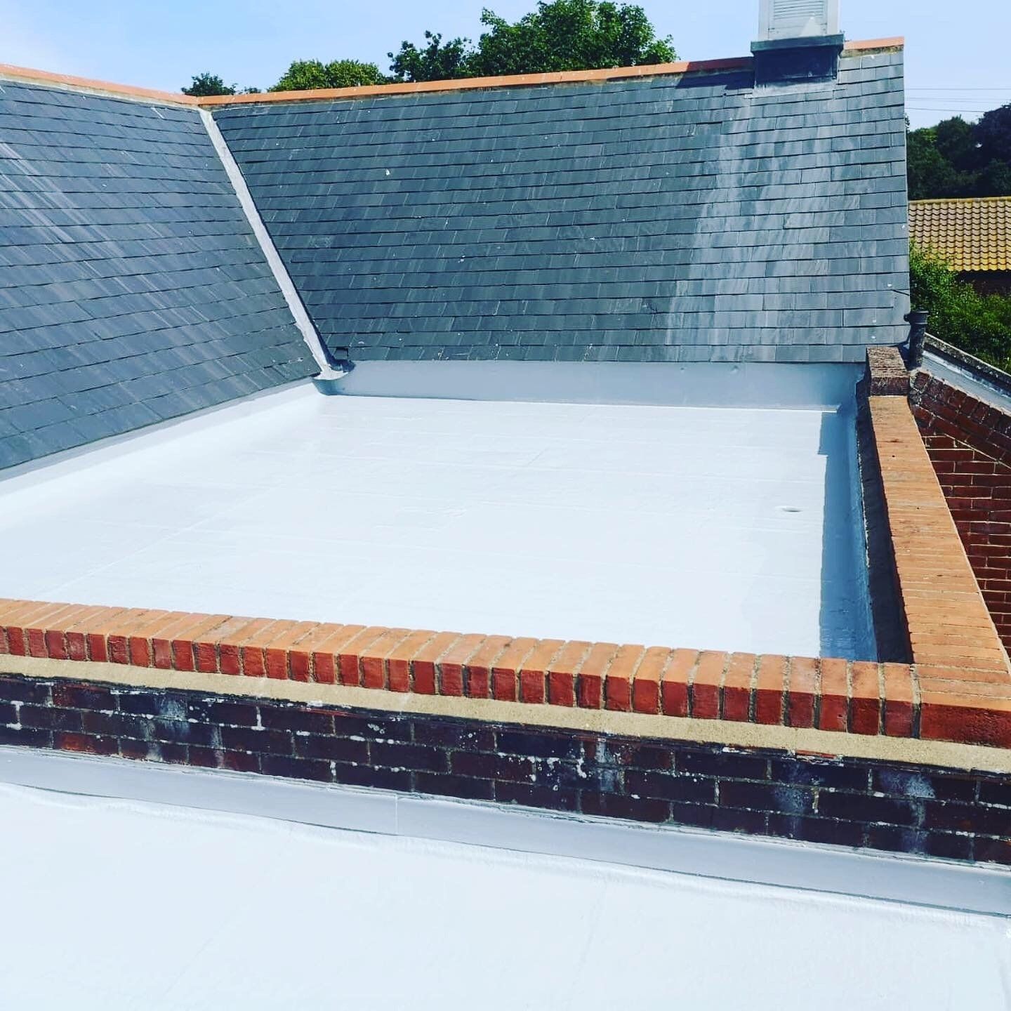 a roof with slate tiles and a white roof