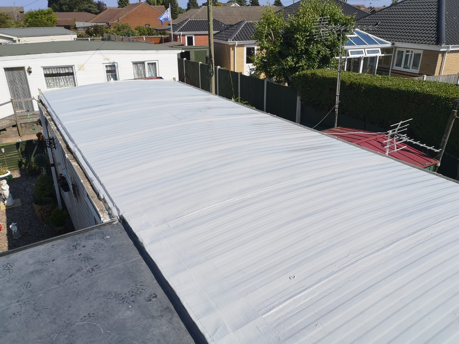 a white roof with a few houses in the background