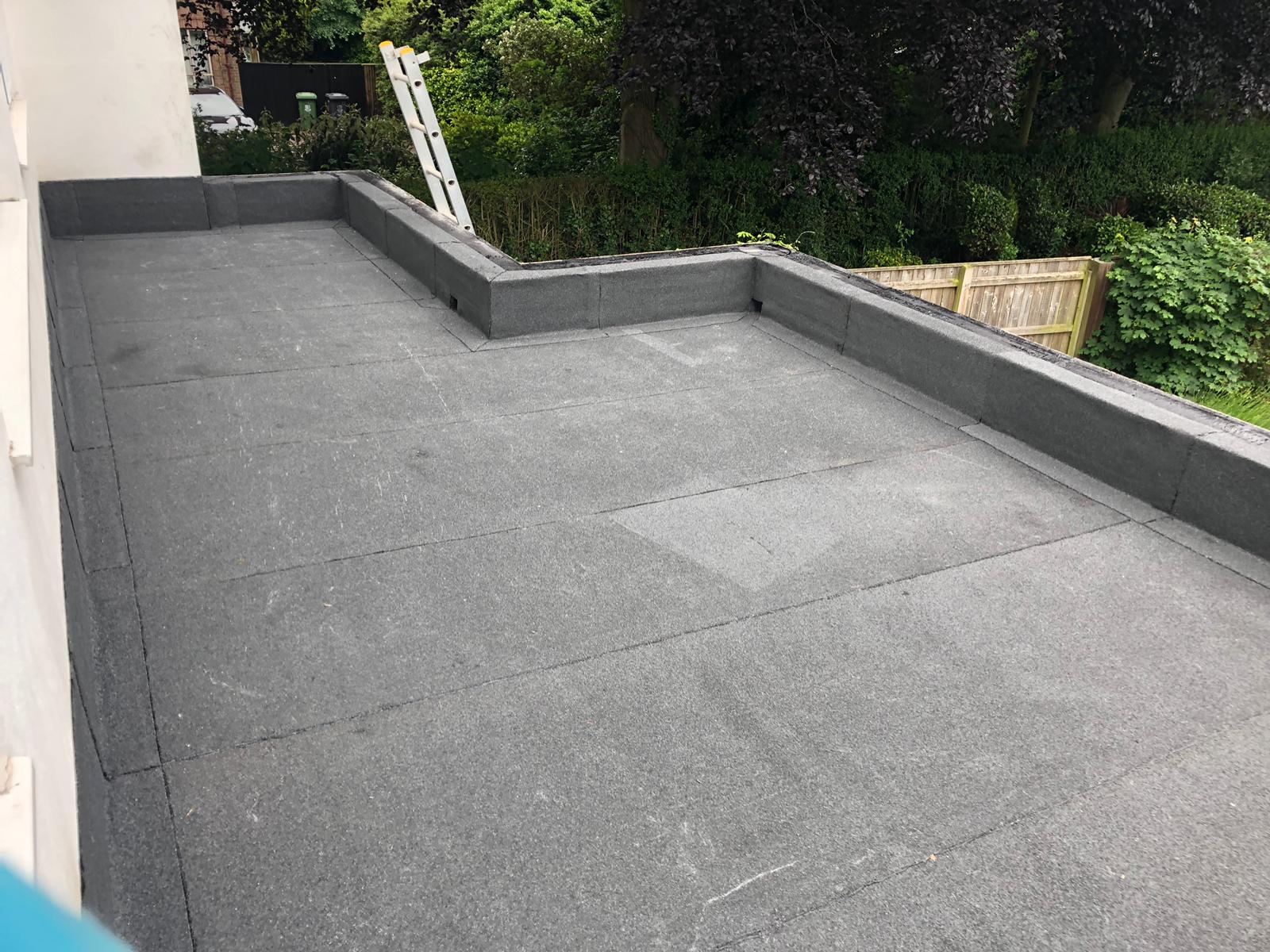 a ladder is sitting on top of a black roof