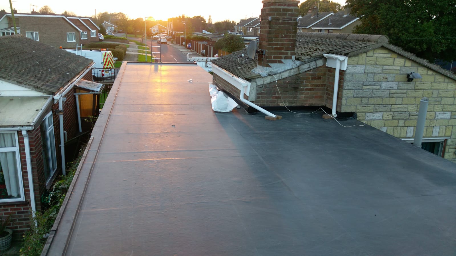 a roof of a house with the sun shining on it