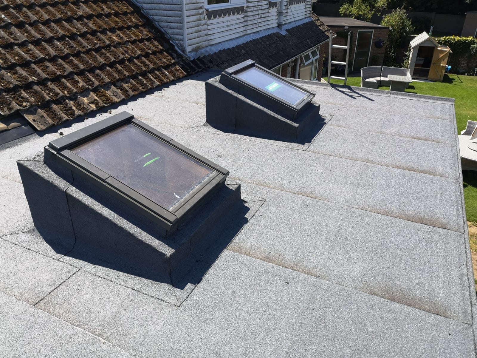 two skylights on the roof of a house