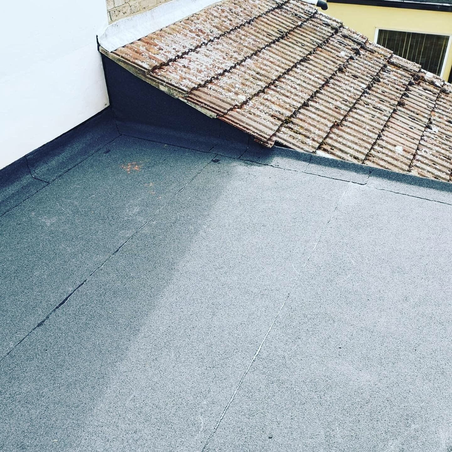 a roof with a tile roof and a gray roof