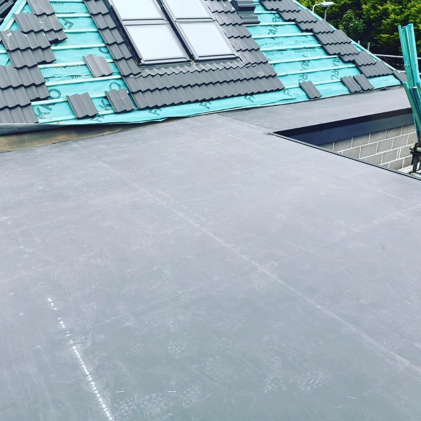 a roof with a skylight is being installed
