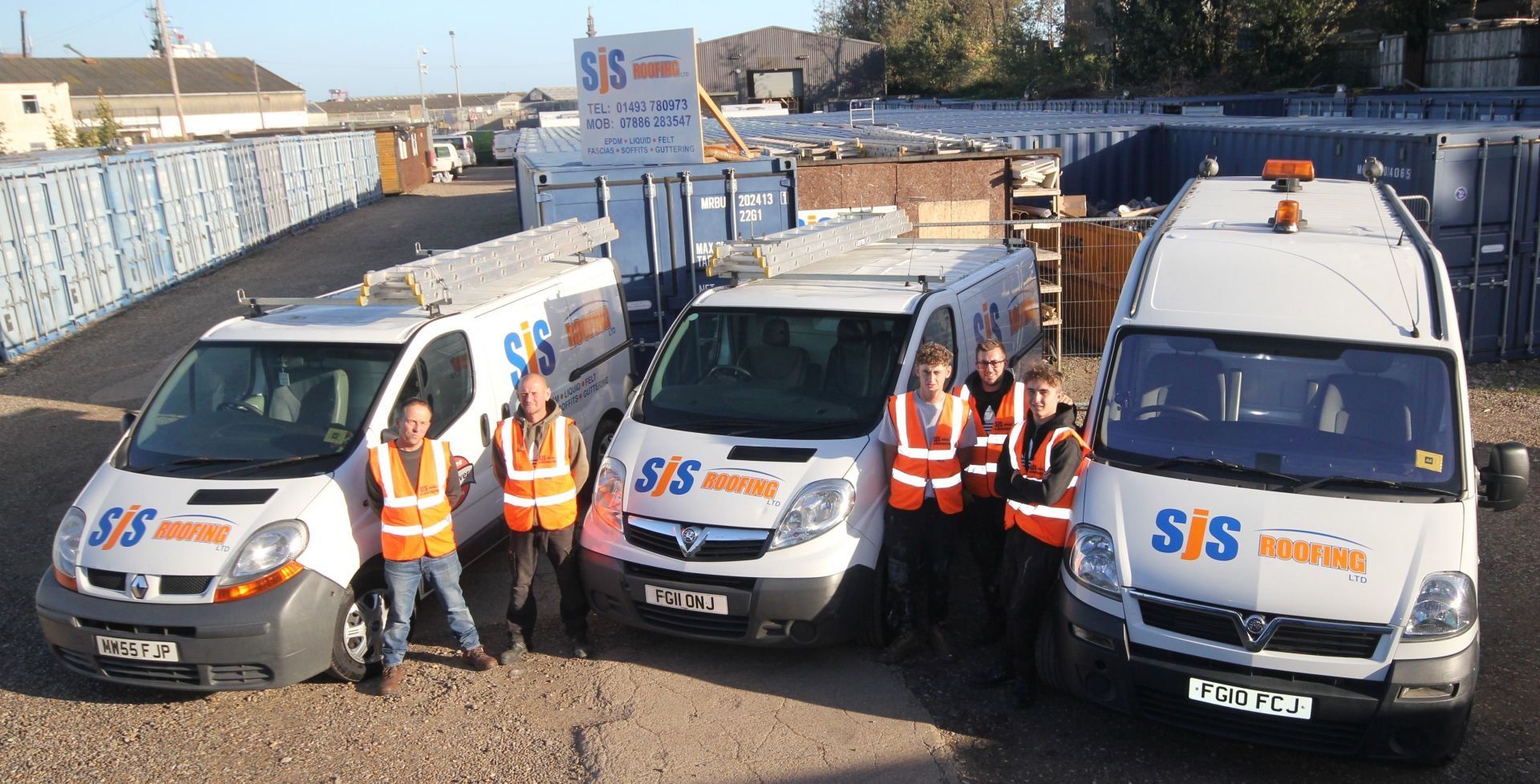 a group of sjs roofing vans are parked next to each other