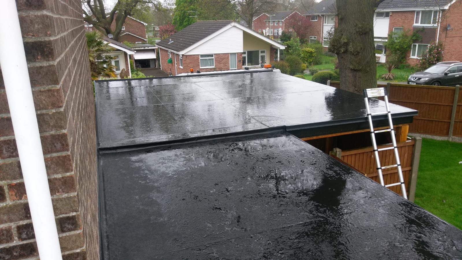 a black roof with a sign that says ' roofing ' on it