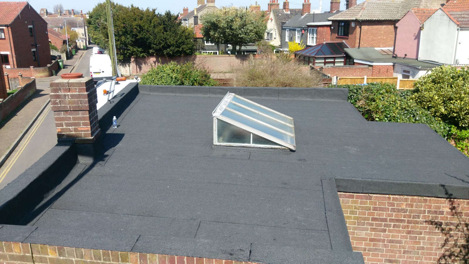 a roof with a skylight and a chimney on it