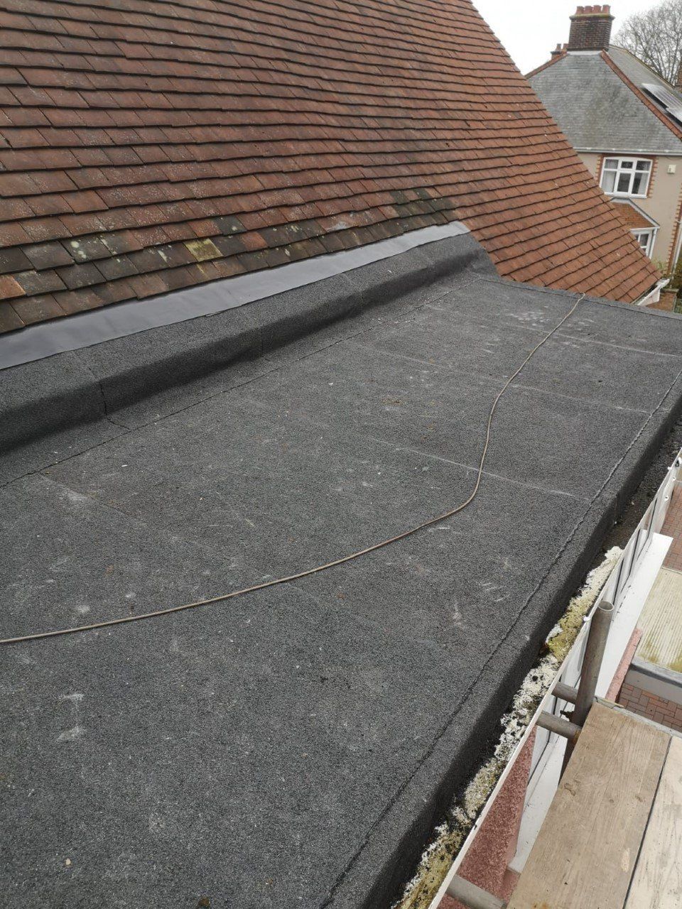 a roof with a black roof and a brown roof
