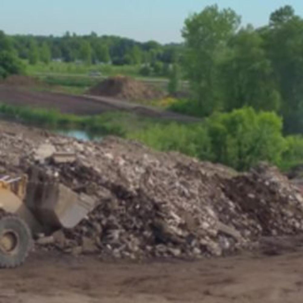Tractor Piling The Rocks — Recycling Services in Medina, MN Tractor Piling The Rocks — Recycling Services in Medina, MN