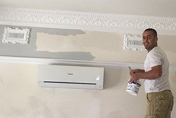 smiling man working on ceiling