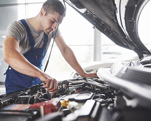 Commercial Transmission — Auto Mechanic Working in Garage in Douglasville, GA Commercial Transmission — Auto Mechanic Working in Garage in Douglasville, GA