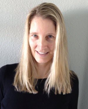 A woman with long blonde hair is smiling and wearing a black shirt.