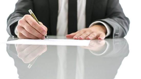 Lawyer signing document