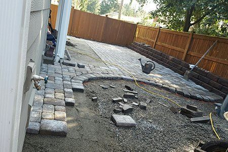 Maintenance — Brick Backyard With Retaining Wall During In Everett, WA Maintenance — Brick Backyard With Retaining Wall During In Everett, WA