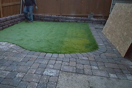 Sod Installation — Brick Backyard With Retaining Wall And New Sod Finished In Everett, WA Sod Installation — Brick Backyard With Retaining Wall And New Sod Finished In Everett, WA