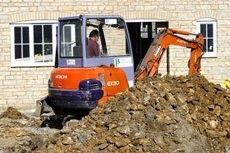 a man sitting in digger for demolishing walls