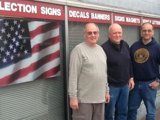 men standing in fron of building - custom signs in Troy, New York
