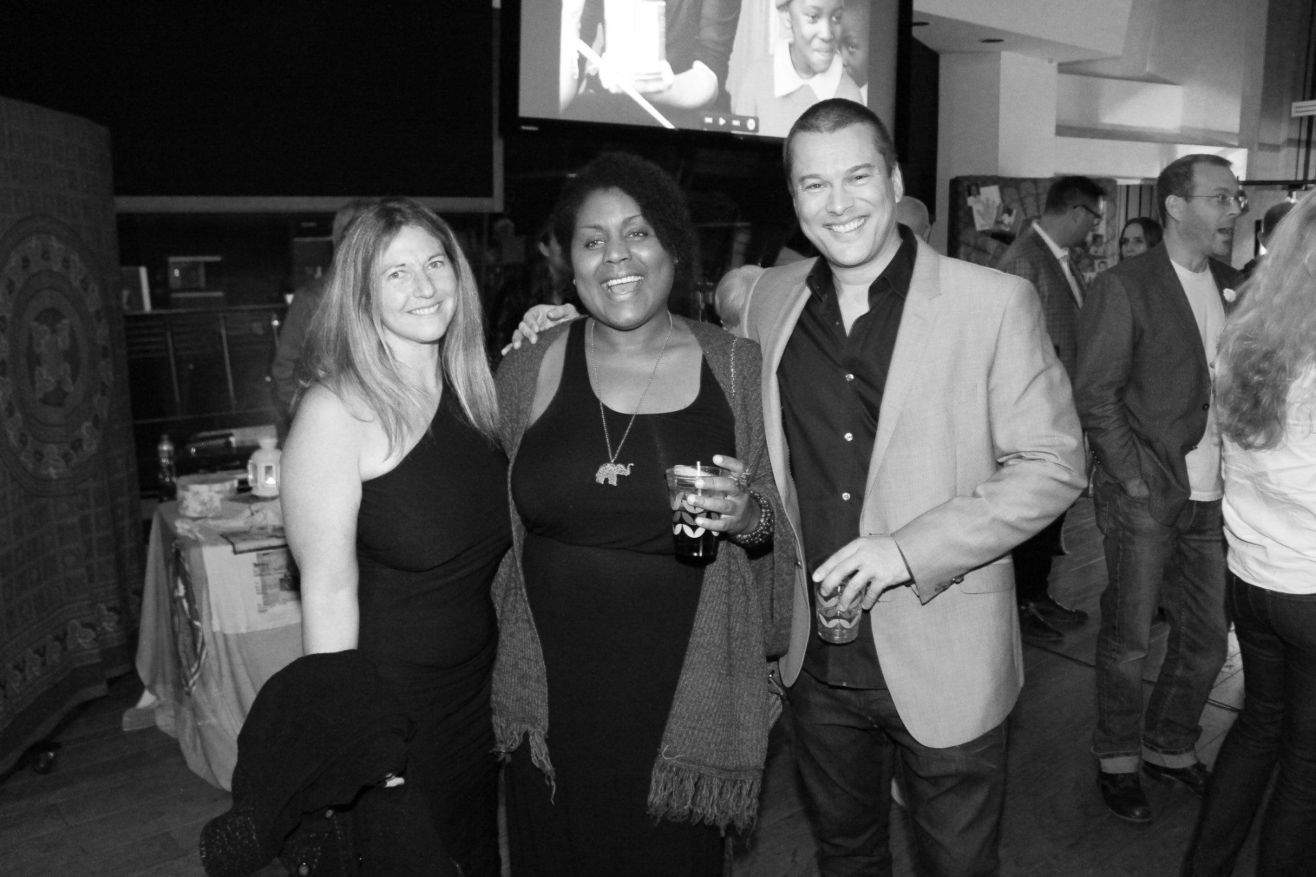 A group of people are posing for a picture in a black and white photo.