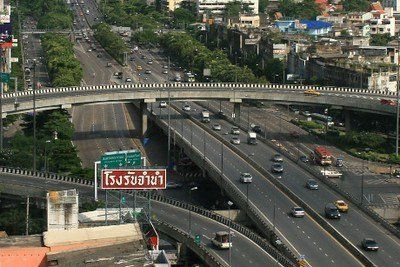 An aerial view of a highway with a sign in a foreign language