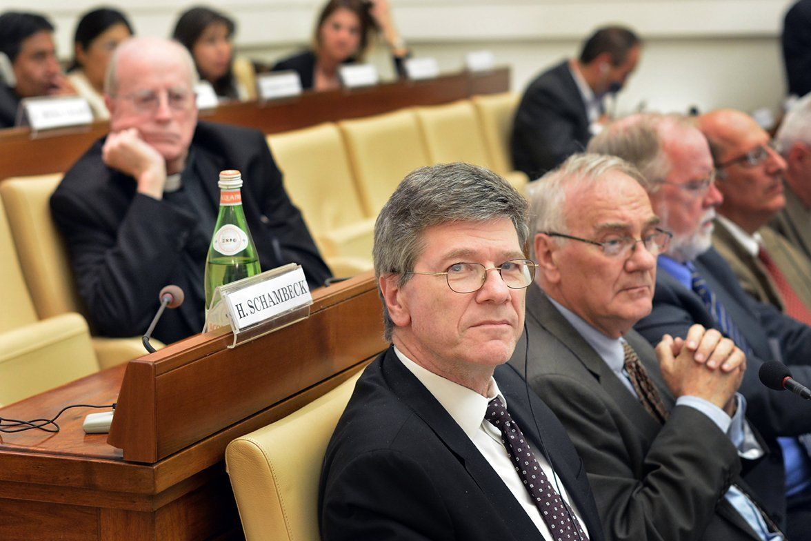A group of men sitting in a meeting room.