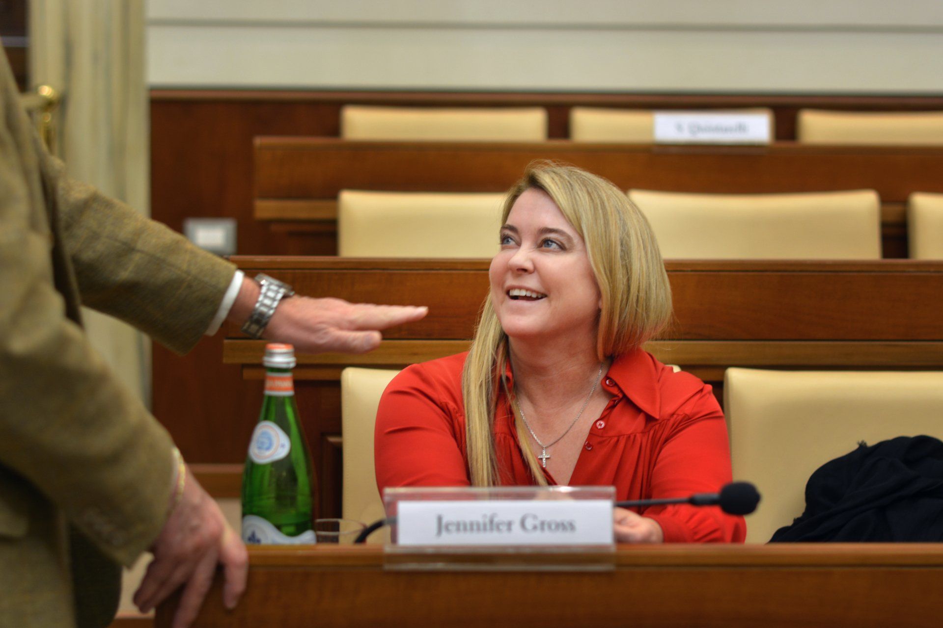 A woman sitting at a desk with a name tag that says Jennifer Gross