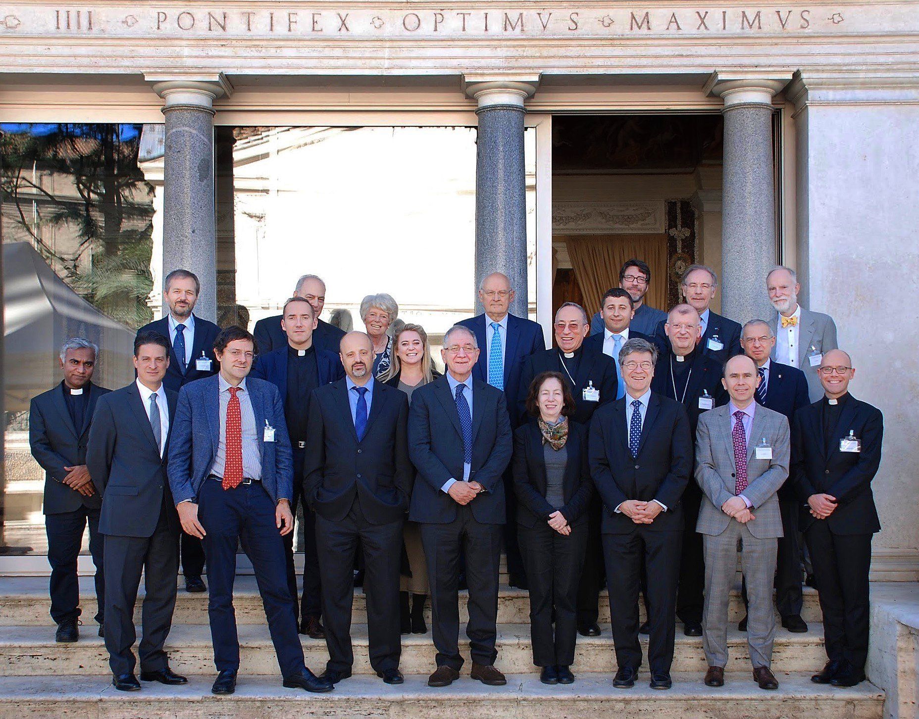 A group of people standing in front of a building that says fontiflex optimvs maximvs