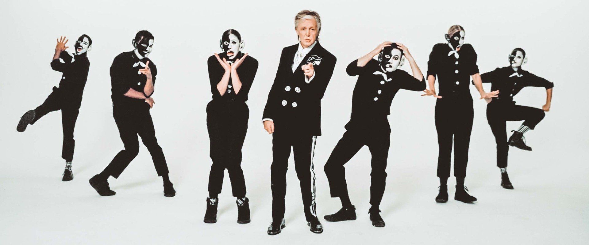A group of people wearing masks are standing in a line.